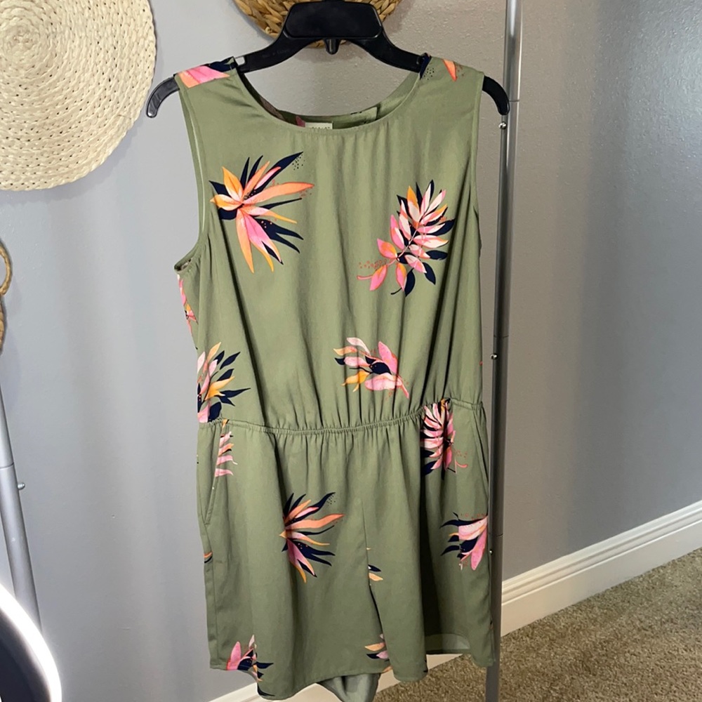 A New Day Green romper with leaf print.